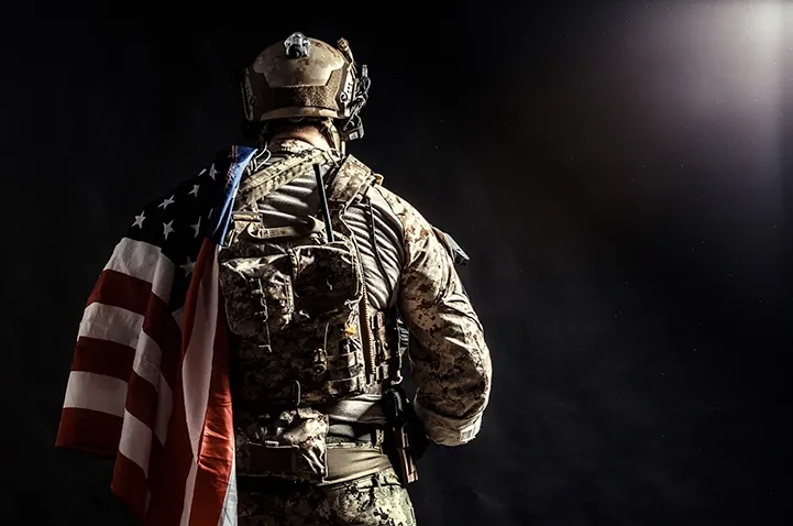 Image of a soldier with an american flag on his shoulder.